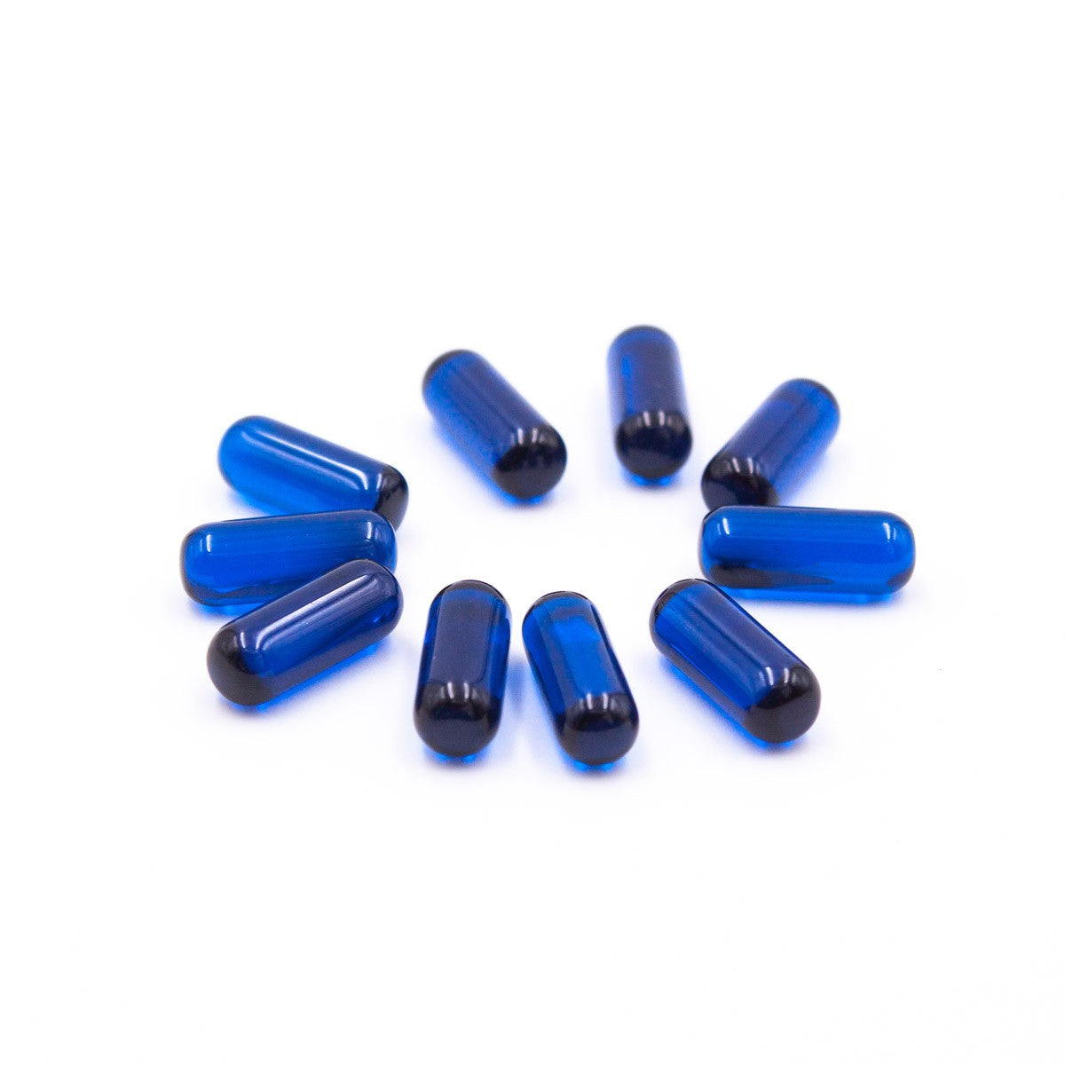 A top-down view of the 15mm Sapphire Terp Pill with a smooth, polished surface against a white background. A top-down view of the 15mm Sapphire Terp Pill with a smooth, polished surface against a white background.
