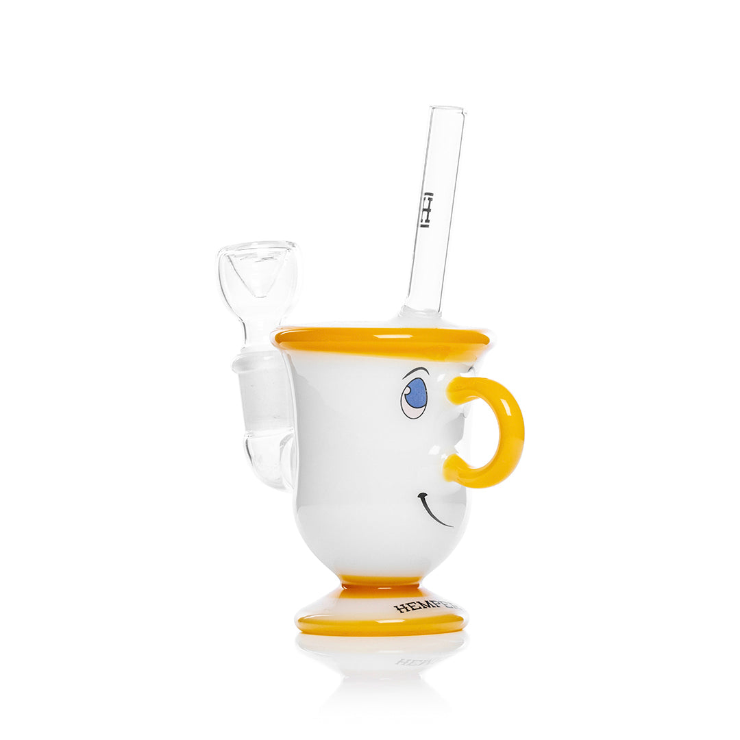 A studio shot displays the Tea Cup Bong, resembling a white teacup with a colorful handle and stem. A studio shot displays the Tea Cup Bong, resembling a white teacup with a colorful handle and stem.