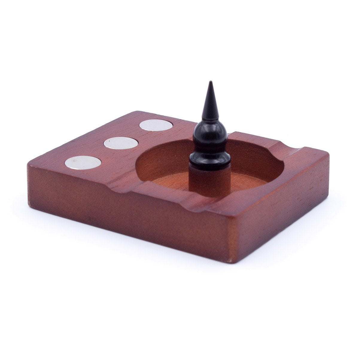 A close-up, angled view of the DynaVap 3-Device Wooden Debowler Base with a dark metal tool resting inside its shallow wooden dish. A close-up, angled view of the DynaVap 3-Device Wooden Debowler Base with a dark metal tool resting inside its shallow wooden dish.