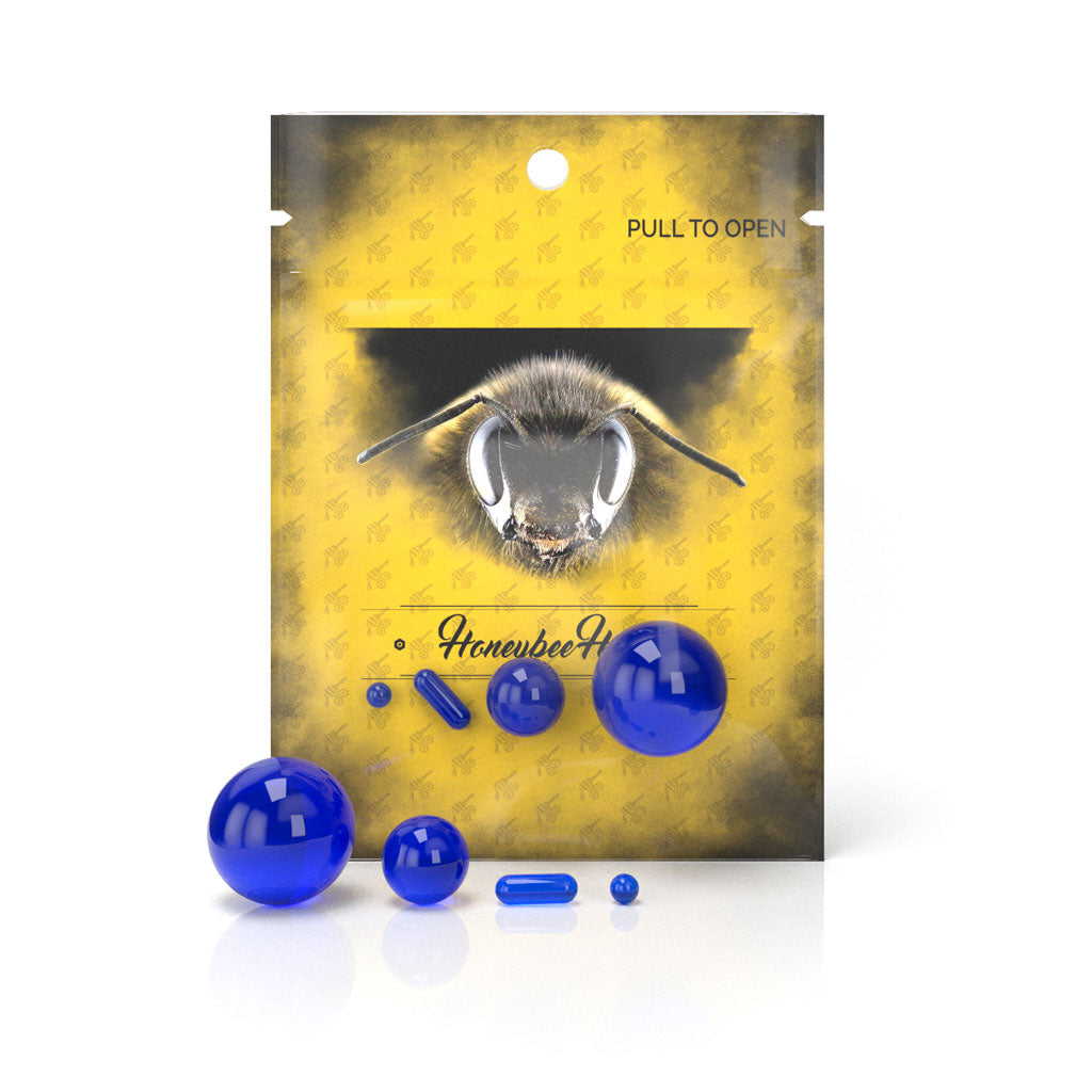 A close-up of the Dab Marble 4-Piece Set shows four vibrant blue glass marbles against a neutral background. A close-up of the Dab Marble 4-Piece Set shows four vibrant blue glass marbles against a neutral background.