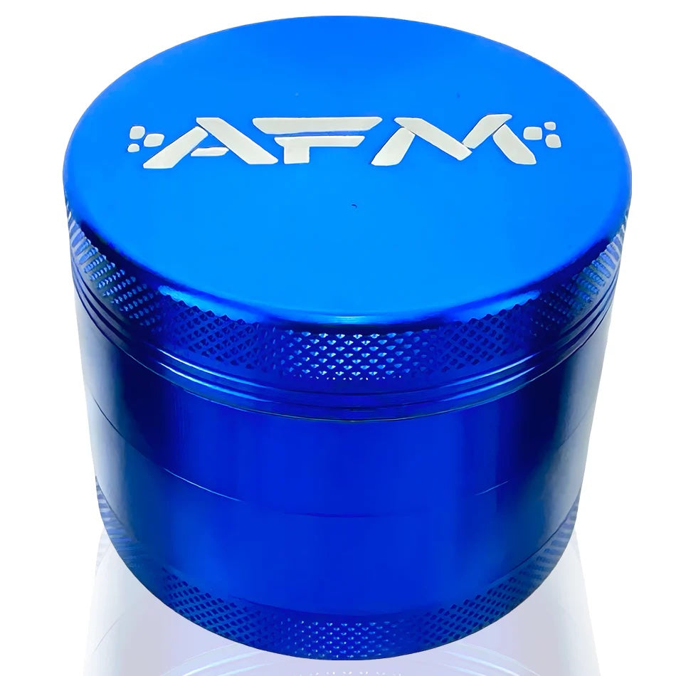 A close-up, angled view of the 4-Piece Aluminum Herb Grinder with a silver tooth arrangement inside the blue metal casing. A close-up, angled view of the 4-Piece Aluminum Herb Grinder with a silver tooth arrangement inside the blue metal casing.