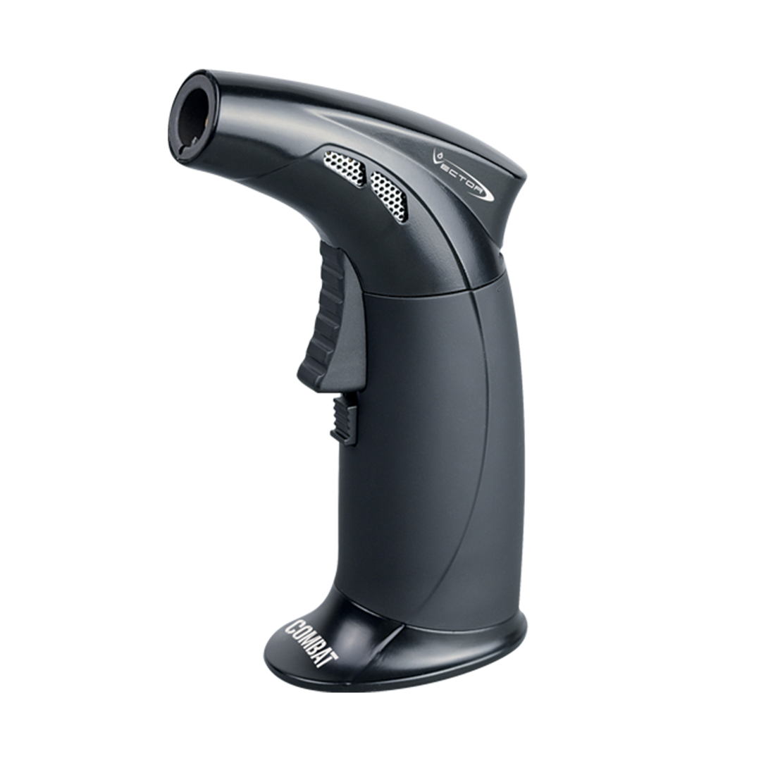 A close-up view of the black Combat Mini Torch with a textured grip and angled nozzle. A close-up view of the black Combat Mini Torch with a textured grip and angled nozzle.