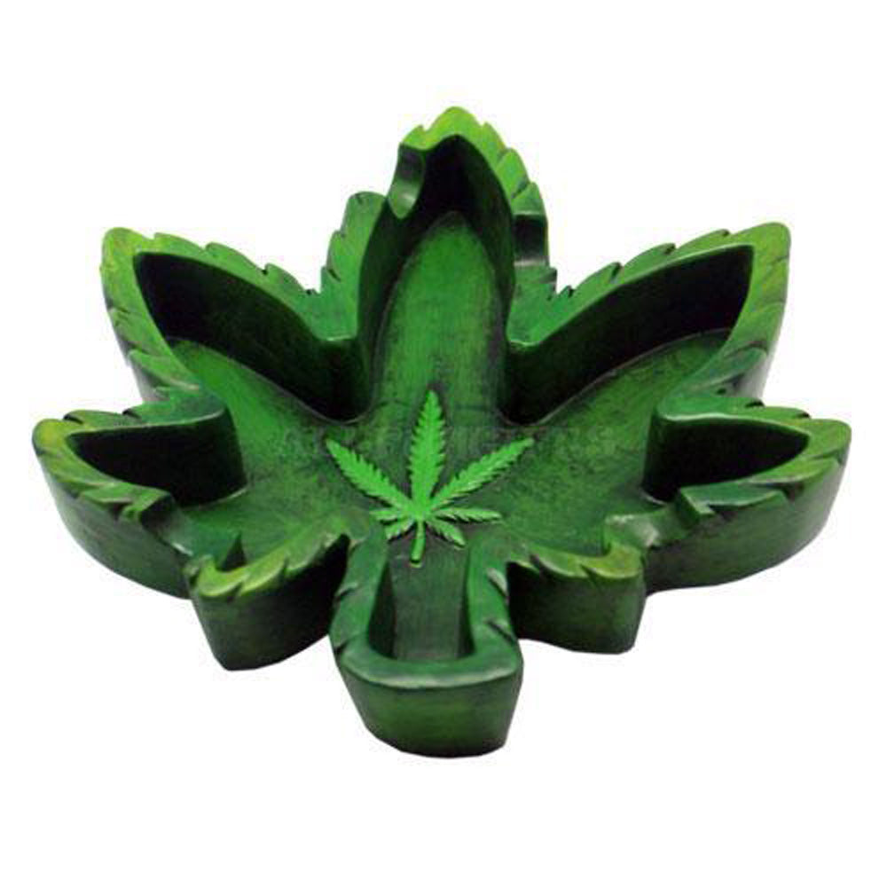 The Hemp Leaf Inception Ashtray is pictured from above, showing its intricate, layered leaf design in a dark green hue. The Hemp Leaf Inception Ashtray is pictured from above, showing its intricate, layered leaf design in a dark green hue.