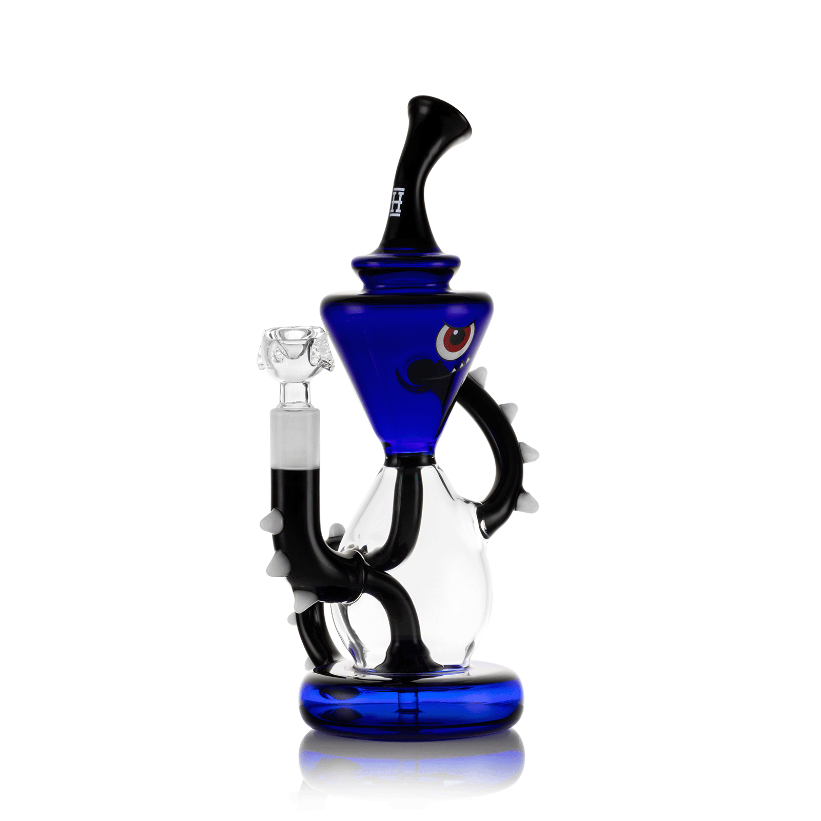 A three-quarter view showcases the Candy Monster XL Bong, its blue glass curving into a unique, monster-inspired design against a dark reflection. A three-quarter view showcases the Candy Monster XL Bong, its blue glass curving into a unique, monster-inspired design against a dark reflection.
