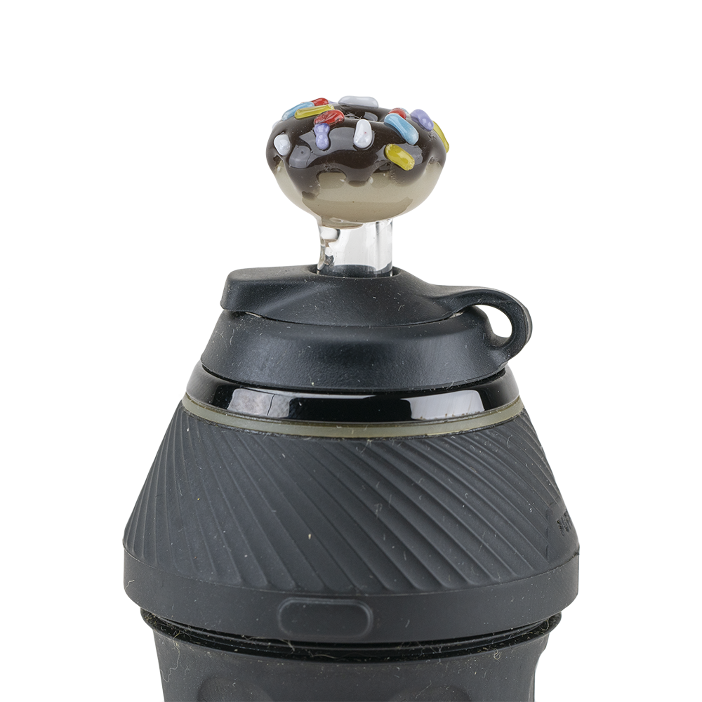 A close-up shot of the Donut PuffCo Proxy Glass Ball Cap, featuring a rounded, translucent cap set atop a black base. A close-up shot of the Donut PuffCo Proxy Glass Ball Cap, featuring a rounded, translucent cap set atop a black base.