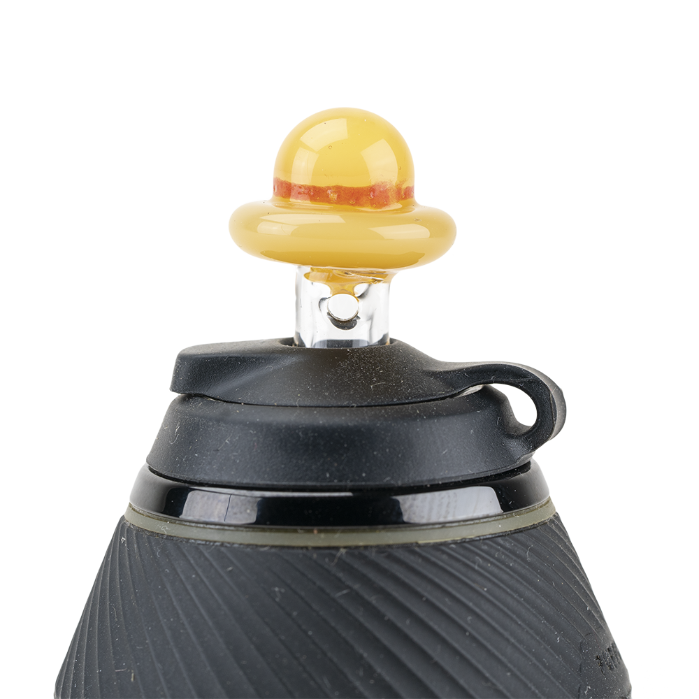A close-up, angled view of the PuffCo Proxy Glass Ball Cap, showcasing its rounded, translucent yellow form. A close-up, angled view of the PuffCo Proxy Glass Ball Cap, showcasing its rounded, translucent yellow form.