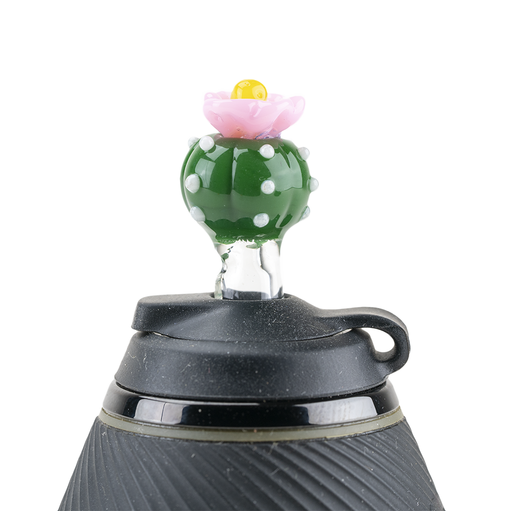 A close-up, angled view of the Peyote PuffCo Proxy Glass Ball Cap, showing its textured, spherical shape against a plain background. A close-up, angled view of the Peyote PuffCo Proxy Glass Ball Cap, showing its textured, spherical shape against a plain background.