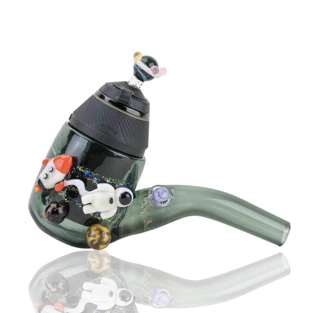 A three-quarter view of the Galactic PuffCo Proxy Glass Attachment Set, showcasing its curved form and clear glass construction. A three-quarter view of the Galactic PuffCo Proxy Glass Attachment Set, showcasing its curved form and clear glass construction.