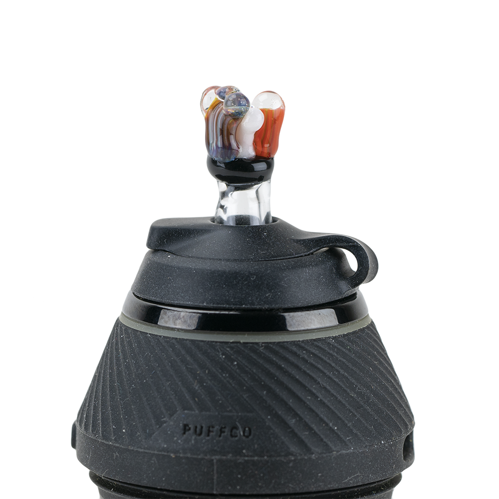 A close-up, angled view of the Coral PuffCo Proxy Glass Ball Cap, showcasing its rounded shape and reflective surface. A close-up, angled view of the Coral PuffCo Proxy Glass Ball Cap, showcasing its rounded shape and reflective surface.