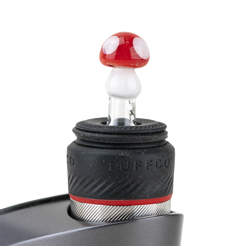 A close-up, angled view of the Mushroom PuffCo Peak Pro Glass Ball Cap, showcasing its translucent, spherical shape. A close-up, angled view of the Mushroom PuffCo Peak Pro Glass Ball Cap, showcasing its translucent, spherical shape.