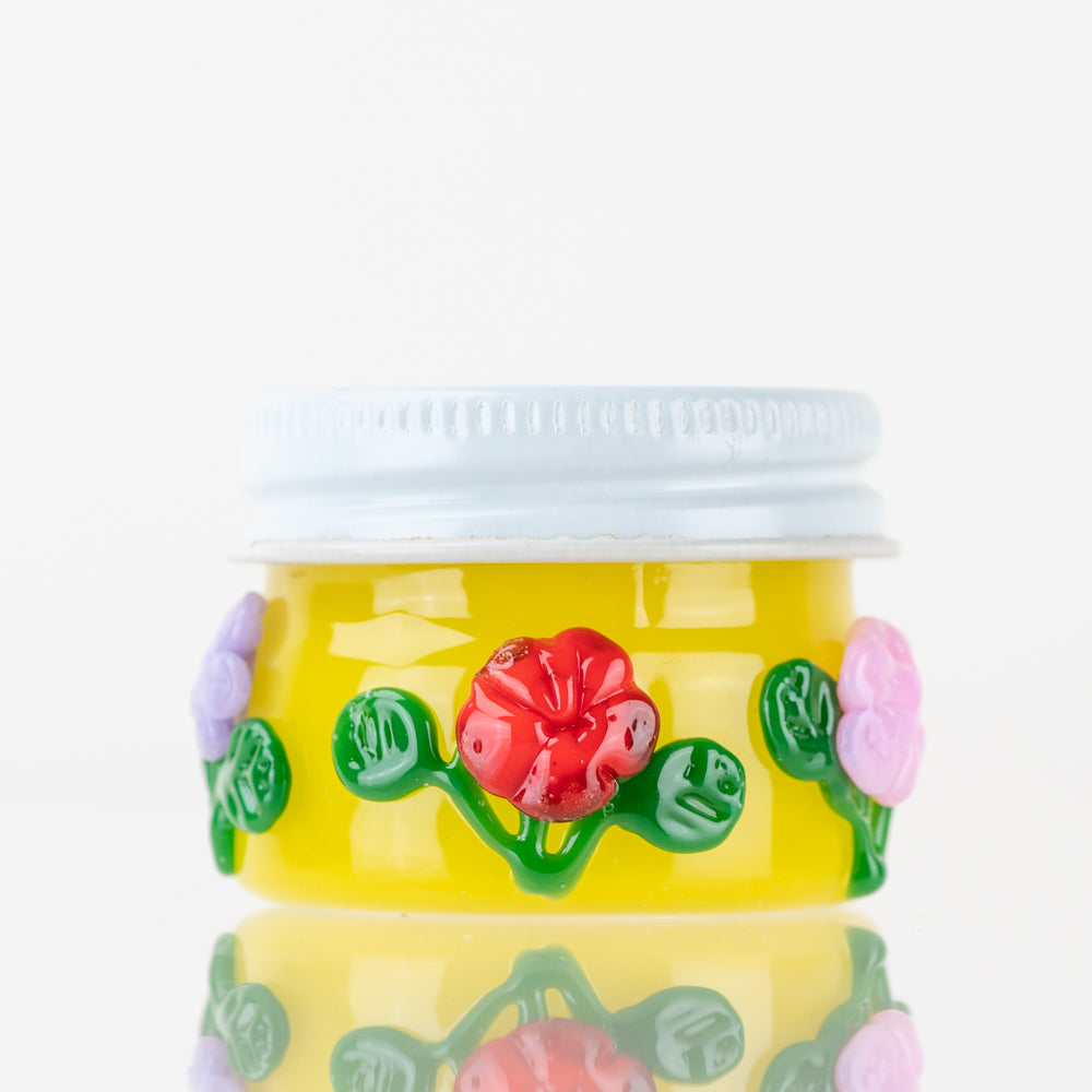 Close-up of the Sunshine Garden Terp Jar, showcasing its vibrant, floral design against a neutral background. Close-up of the Sunshine Garden Terp Jar, showcasing its vibrant, floral design against a neutral background.