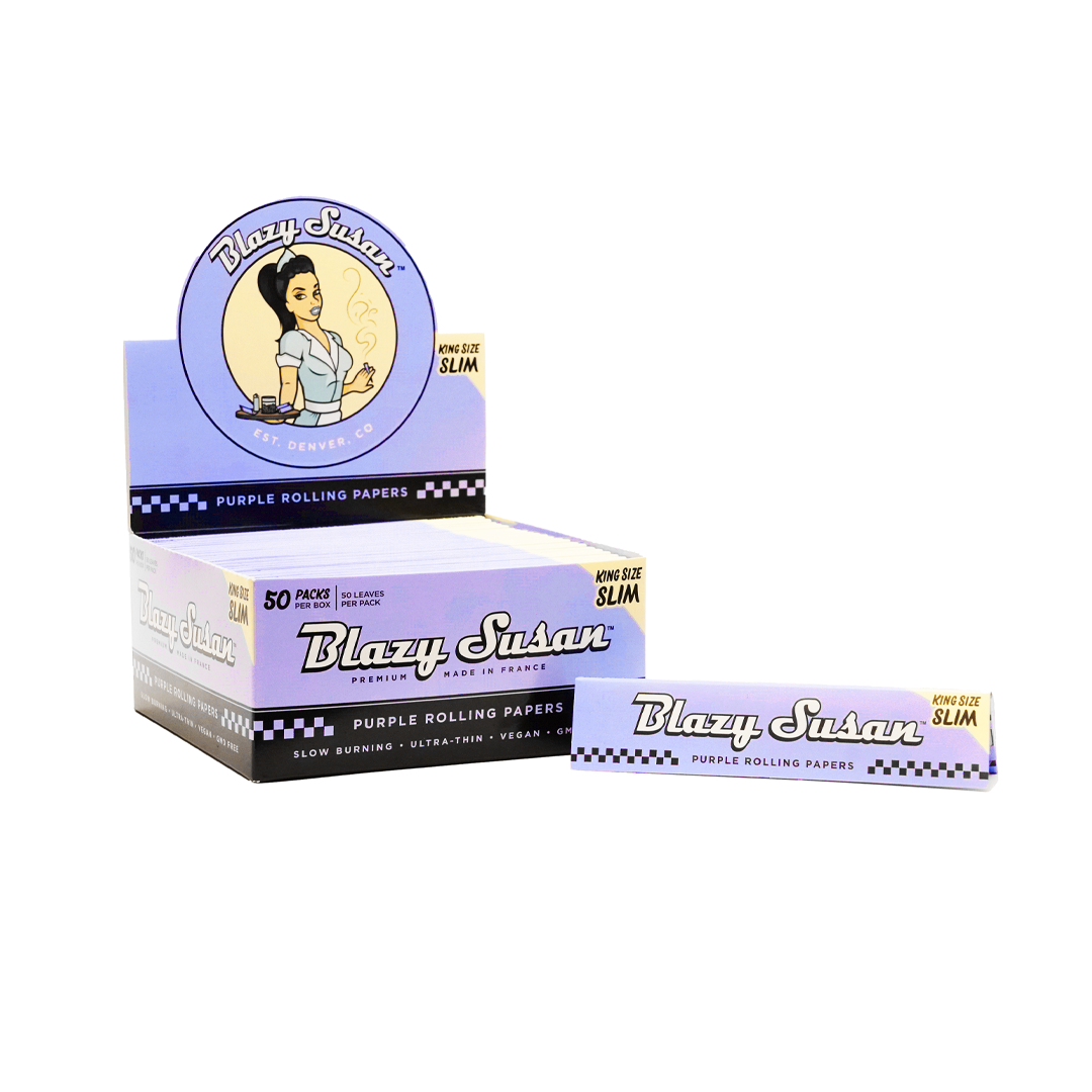 Purple Rolling Papers package with a vintage-style design, angled slightly, showcasing bold lettering and color scheme. Purple Rolling Papers package with a vintage-style design, angled slightly, showcasing bold lettering and color scheme.