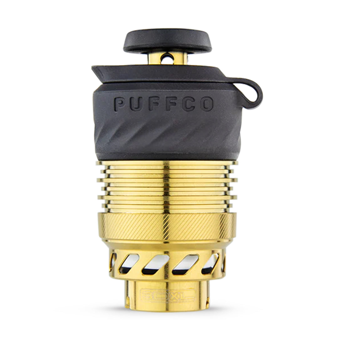 Close-up of the gold Puffco Peak Pro 3D XL Chamber, showcasing its textured metallic finish and cylindrical shape. Close-up of the gold Puffco Peak Pro 3D XL Chamber, showcasing its textured metallic finish and cylindrical shape.