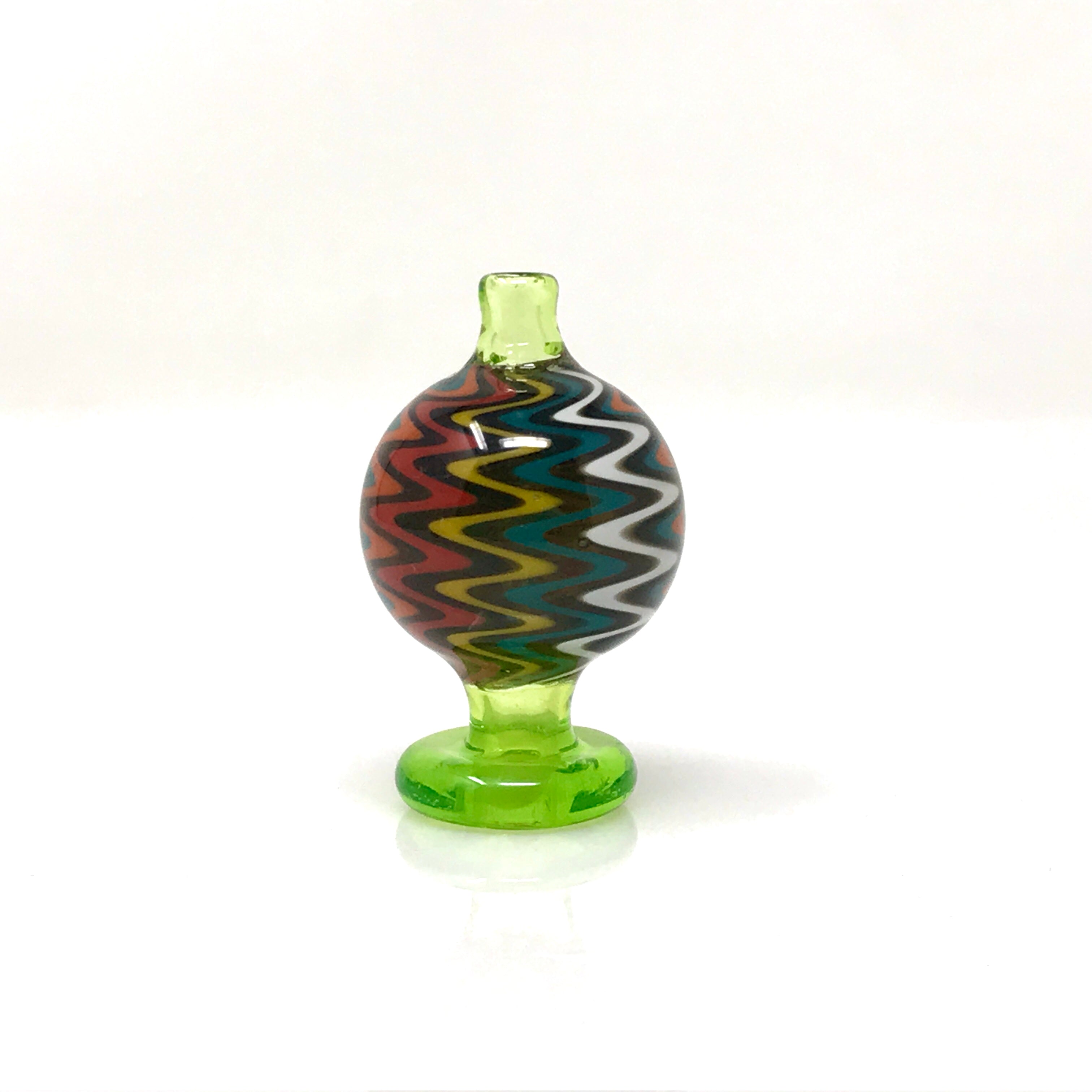 A close-up, angled view of the Color Reversal Bubble Carb Cap, showcasing its vibrant, swirling glass pattern. A close-up, angled view of the Color Reversal Bubble Carb Cap, showcasing its vibrant, swirling glass pattern.
