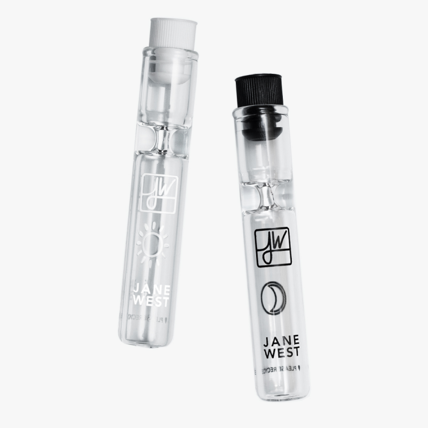 Front view of the Day & Night Travel Pipe Set, a clear glass pipe with a branded logo against a plain white background. Front view of the Day & Night Travel Pipe Set, a clear glass pipe with a branded logo against a plain white background.