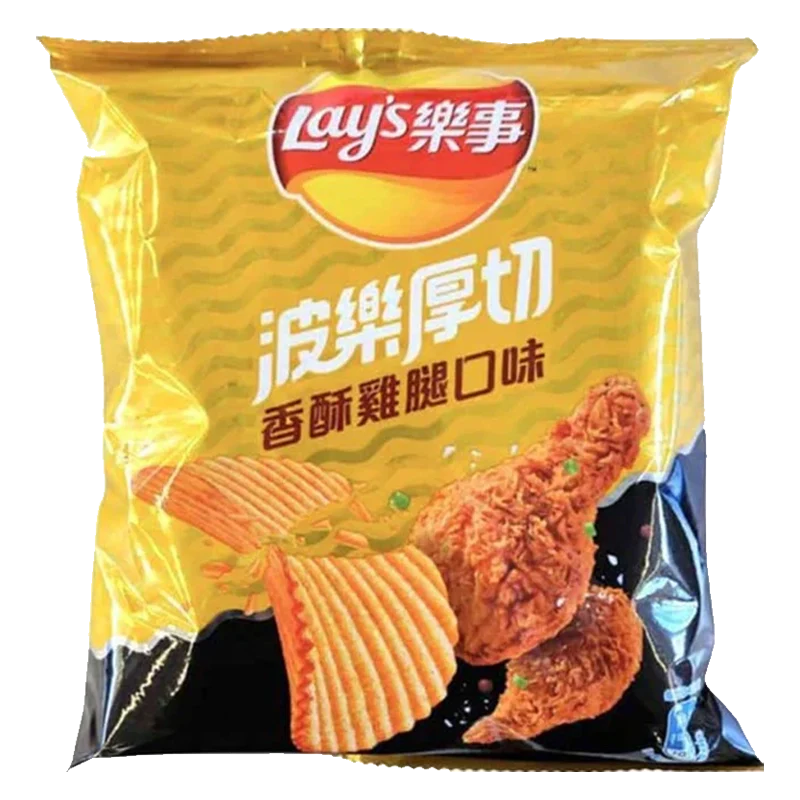 A close-up shows Lay's Chips - Crispy Fried Chicken, shaped like golden-brown fried chicken pieces against a dark background. A close-up shows Lay's Chips - Crispy Fried Chicken, shaped like golden-brown fried chicken pieces against a dark background.