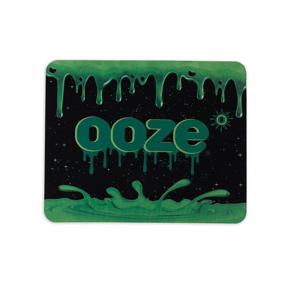 A top-down view of the Ooze Mouse Pad displaying a dark, liquid-like design with a glossy finish. A top-down view of the Ooze Mouse Pad displaying a dark, liquid-like design with a glossy finish.