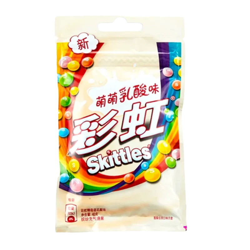 A colorful package of Skittles - Fruit Yogurt Candy is displayed against a white background with text in a foreign language. A colorful package of Skittles - Fruit Yogurt Candy is displayed against a white background with text in a foreign language.