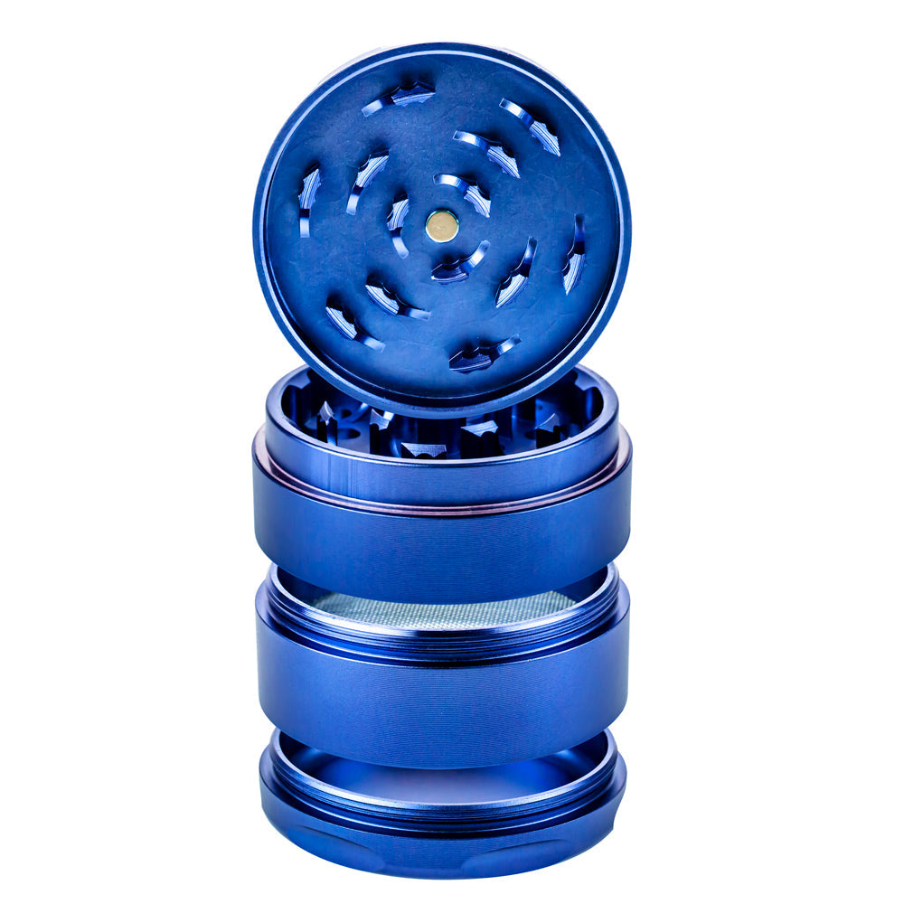 A close-up, angled view of the 4-Piece Grinder, showcasing its stacked, metallic pieces with an open top section. A close-up, angled view of the 4-Piece Grinder, showcasing its stacked, metallic pieces with an open top section.