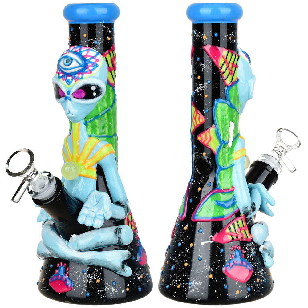 Front view of the Artist Series Glow Beaker Water Pipe, a black glass beaker with a vibrant, glowing alien design. Front view of the Artist Series Glow Beaker Water Pipe, a black glass beaker with a vibrant, glowing alien design.