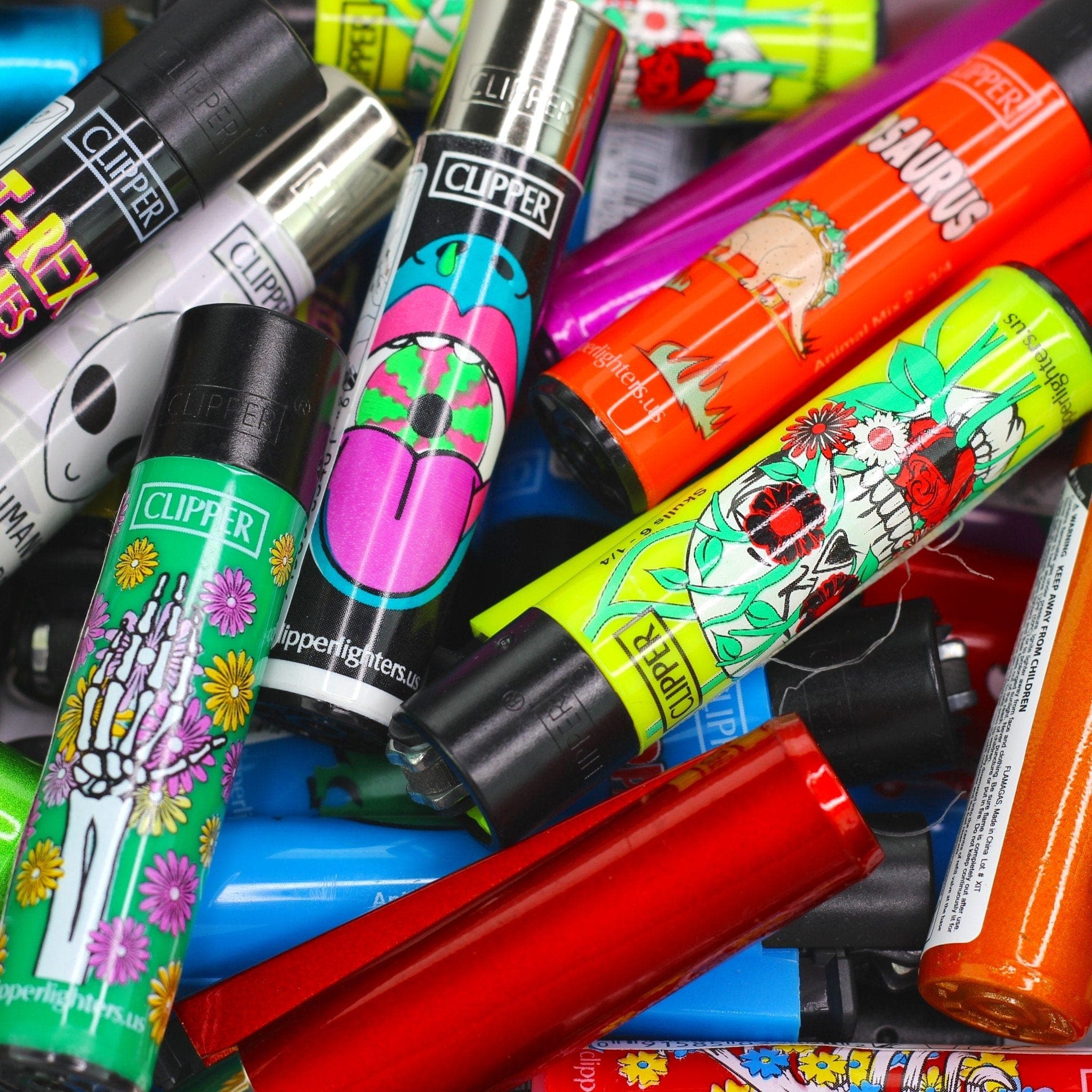 A colorful assortment of Clipper Assorted Lighters are stacked and displayed against a patterned background in a slightly angled, eye-level shot. A colorful assortment of Clipper Assorted Lighters are stacked and displayed against a patterned background in a slightly angled, eye-level shot.