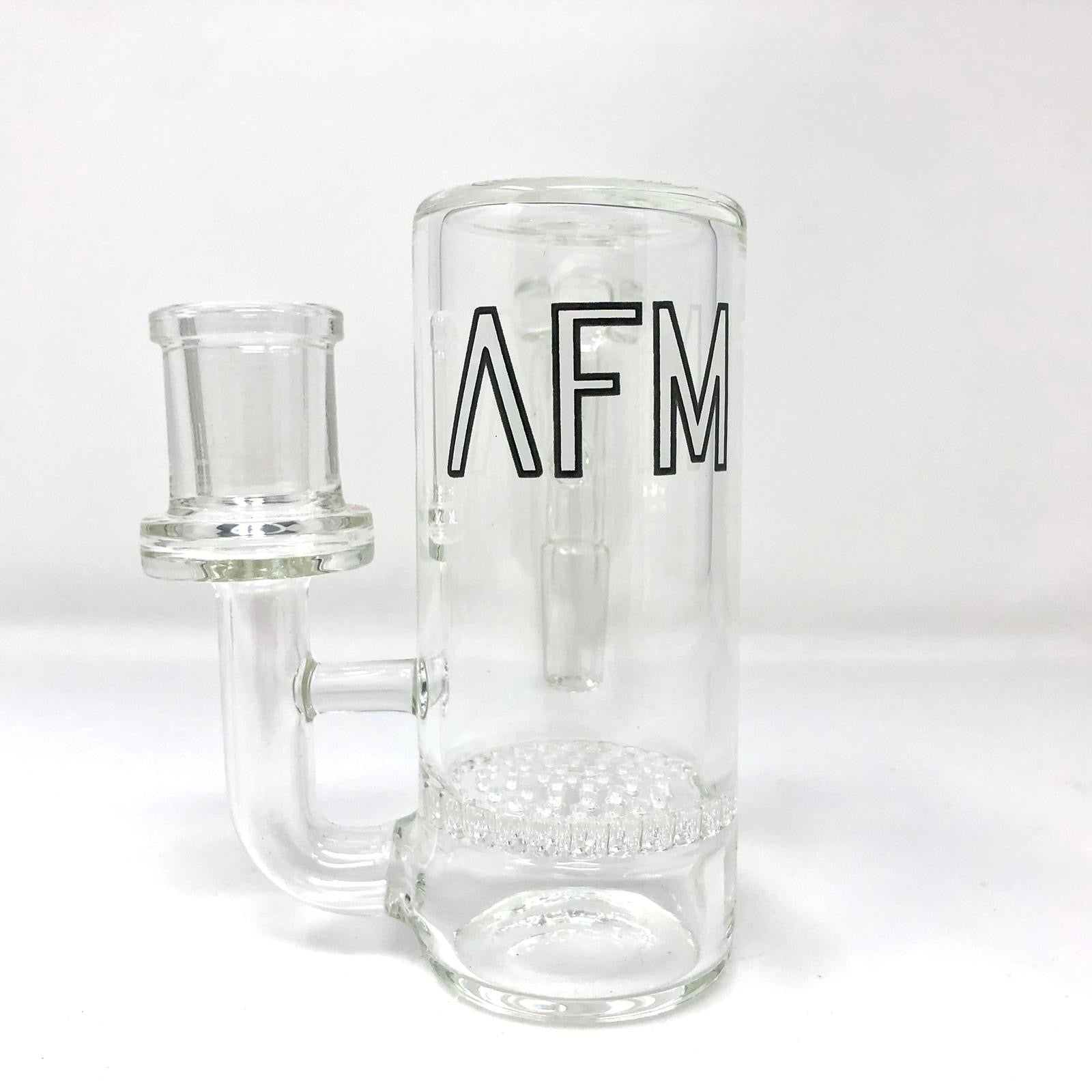 A studio shot of the Honeycomb Perc Glass Ashcatcher, showcasing its clear glass construction and intricate honeycomb perc design. A studio shot of the Honeycomb Perc Glass Ashcatcher, showcasing its clear glass construction and intricate honeycomb perc design.