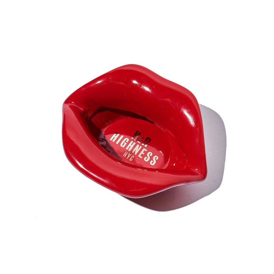 A top-down view of the Lip Service Ashtray, showcasing its glossy, molded shape on a neutral background. A top-down view of the Lip Service Ashtray, showcasing its glossy, molded shape on a neutral background.