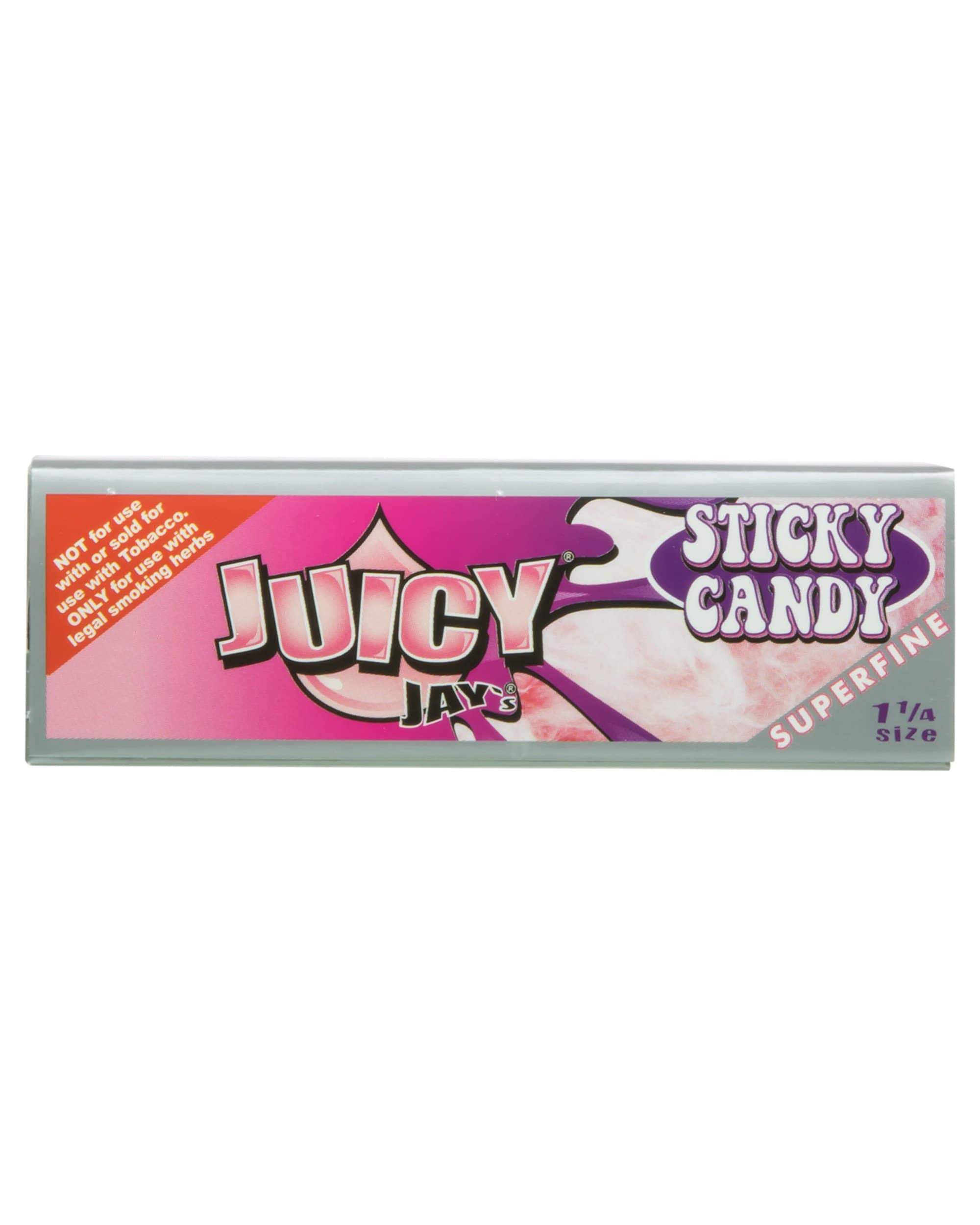 A close-up shot of the Sticky Candy Superfine 1-1/4 Rolling Papers package featuring bold lettering on a colorful background. A close-up shot of the Sticky Candy Superfine 1-1/4 Rolling Papers package featuring bold lettering on a colorful background.