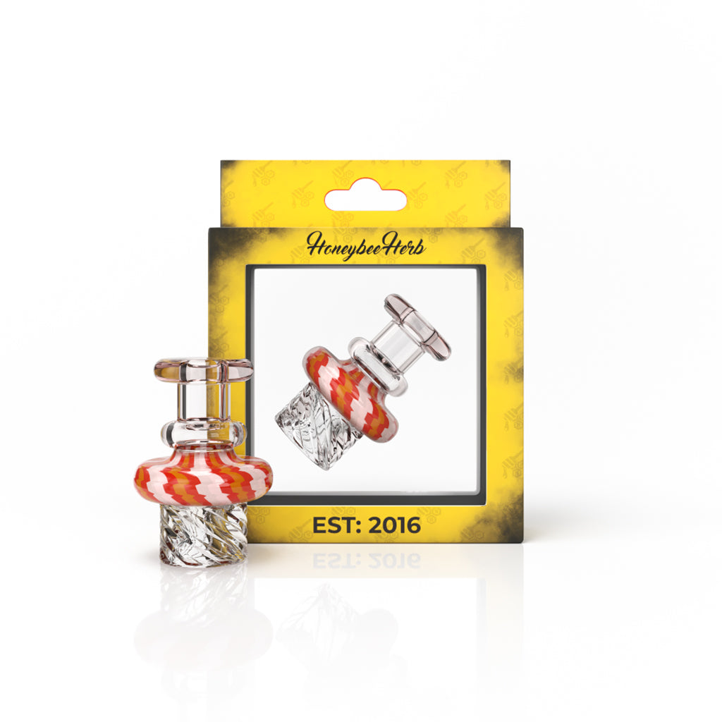 A close-up, angled view of the Honeybee Cyclone Vortex Carb Cap, showcasing its swirling, transparent design. A close-up, angled view of the Honeybee Cyclone Vortex Carb Cap, showcasing its swirling, transparent design.