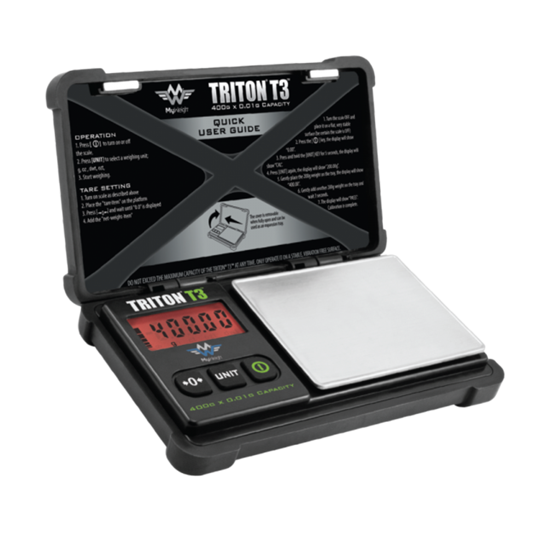 A close-up, angled view of the Triton 3 Scale with a black casing and a digital display, showcasing its user guide on top. A close-up, angled view of the Triton 3 Scale with a black casing and a digital display, showcasing its user guide on top.