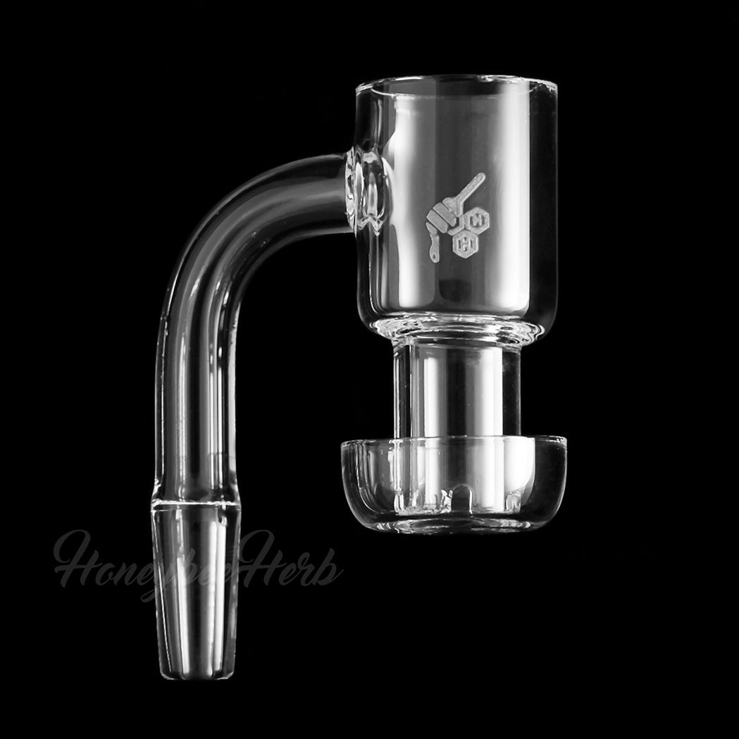 A close-up, angled view of the Honeysuckle Quartz Banger 90° Yellow Line, showcasing its clear quartz construction and distinctive angled joint. A close-up, angled view of the Honeysuckle Quartz Banger 90° Yellow Line, showcasing its clear quartz construction and distinctive angled joint.