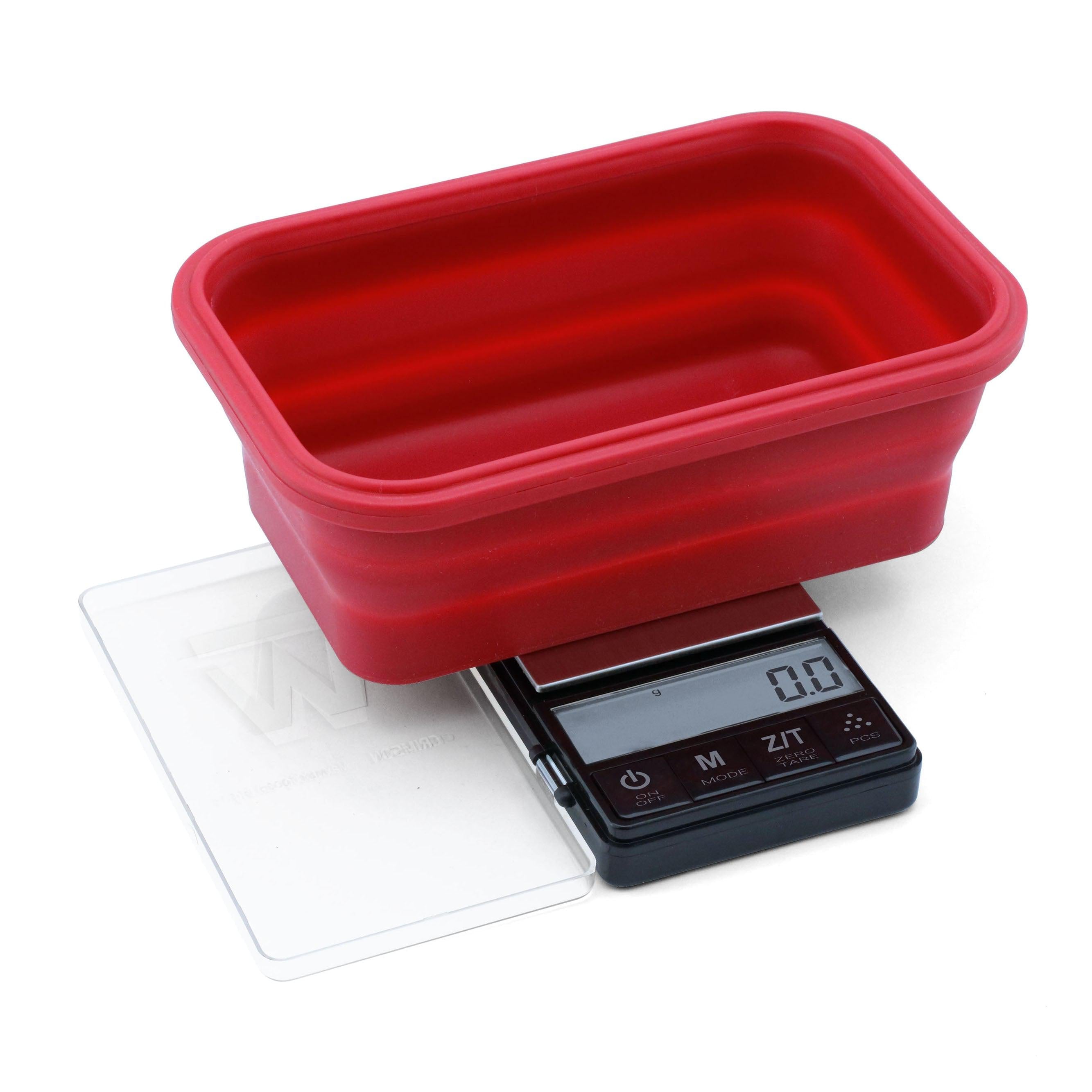 A front view of the Crimson Scale Collapsible Bowl, showing a digital display on its compact, red surface. A front view of the Crimson Scale Collapsible Bowl, showing a digital display on its compact, red surface.