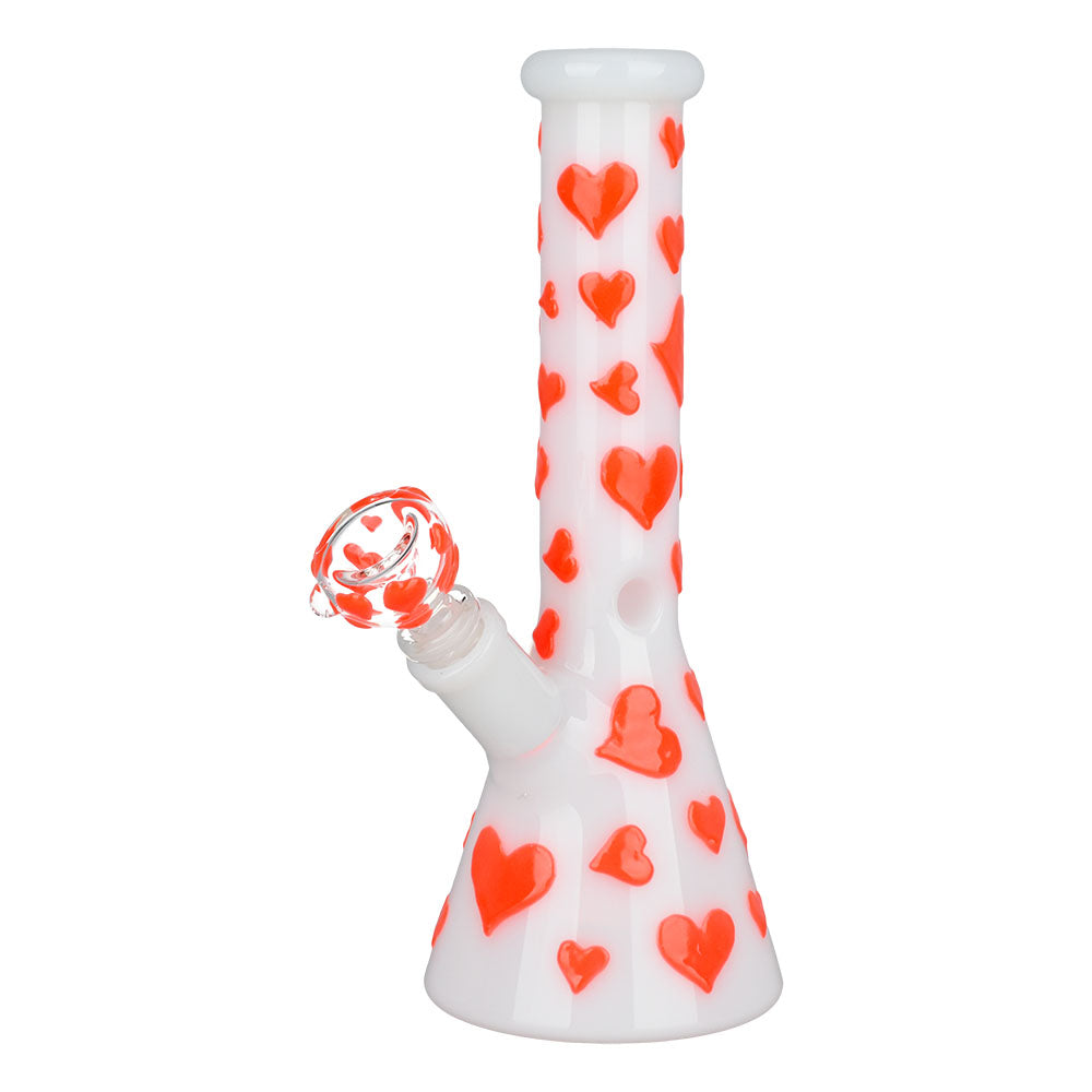 Front view of the Valentines Day Heart Glow In The Dark Beaker, showcasing a clear glass beaker with red heart designs. Front view of the Valentines Day Heart Glow In The Dark Beaker, showcasing a clear glass beaker with red heart designs.