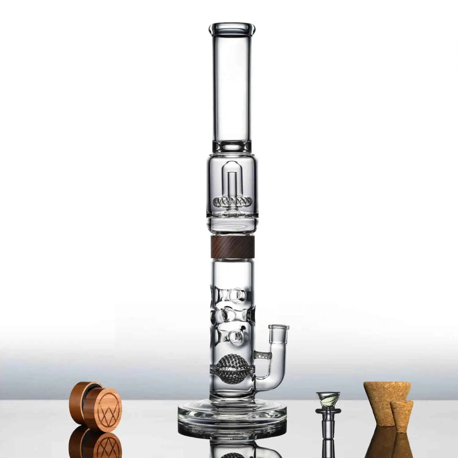 A studio shot displays the Swiss UFO Bong, with its clear glass construction and unique shape reflected on a glossy surface. A studio shot displays the Swiss UFO Bong, with its clear glass construction and unique shape reflected on a glossy surface.