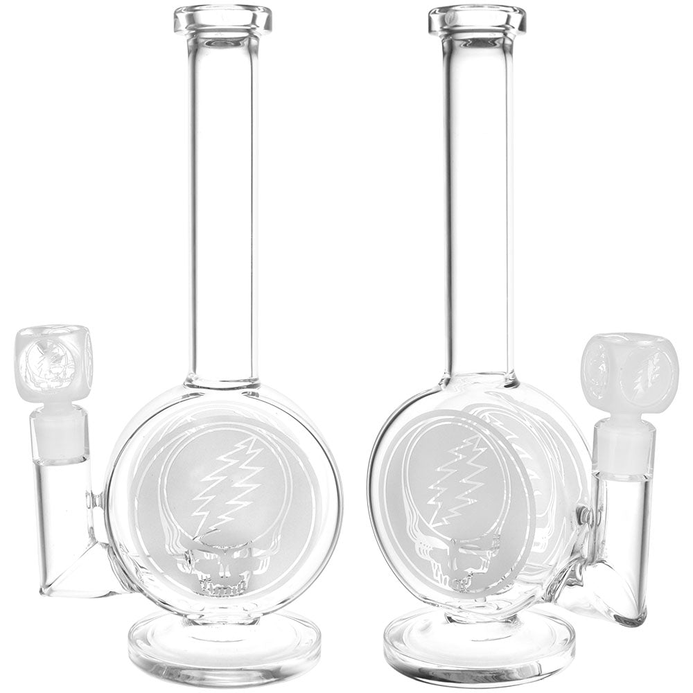 Front view of the Grateful Dead Round Steal Your Face Water Pipe, a clear glass piece with a simple, rounded design. Front view of the Grateful Dead Round Steal Your Face Water Pipe, a clear glass piece with a simple, rounded design.