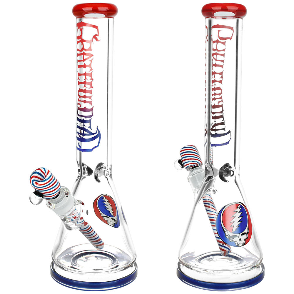 Front view of the Grateful Dead Liberty Beaker Water Pipe, a clear glass beaker with a colorful neck and branded decal. Front view of the Grateful Dead Liberty Beaker Water Pipe, a clear glass beaker with a colorful neck and branded decal.