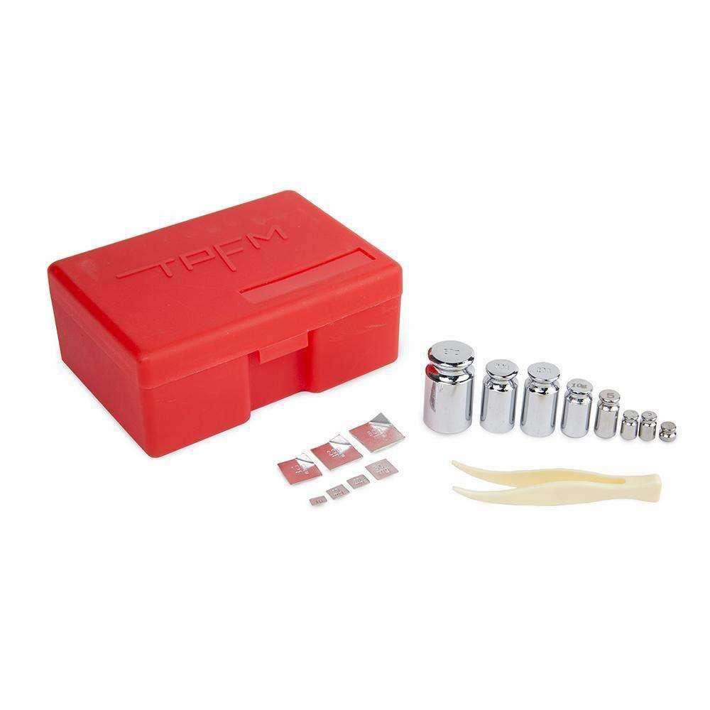 A top-down view of the 16 Piece Calibration Weight Kit, showing silver weights arranged beside a red plastic case. A top-down view of the 16 Piece Calibration Weight Kit, showing silver weights arranged beside a red plastic case.