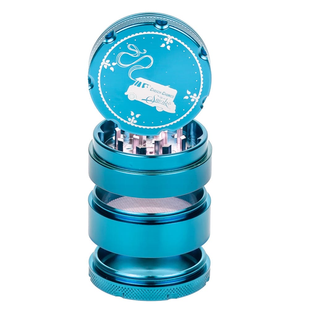 A close-up, angled view of the Up In Smoke 50mm 4-Piece Grinder, showing its metallic, multi-tiered construction. A close-up, angled view of the Up In Smoke 50mm 4-Piece Grinder, showing its metallic, multi-tiered construction.