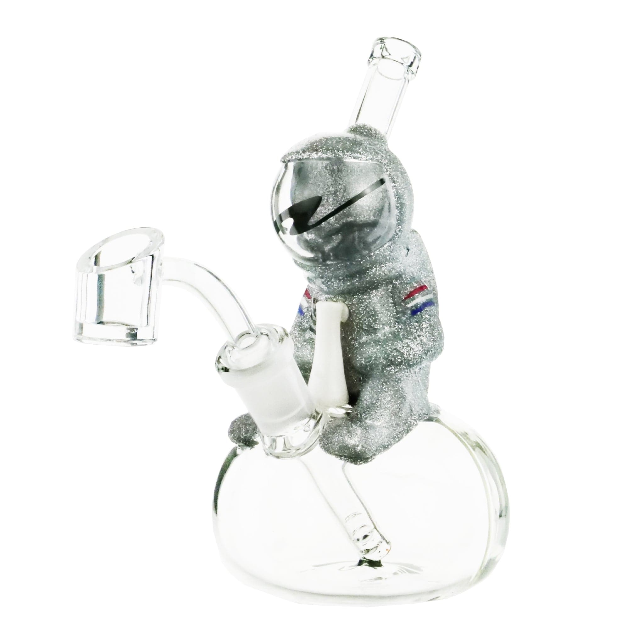 Front view of the Moon Man Rig, a clear glass sculpture depicting an astronaut figure with a rounded base. Front view of the Moon Man Rig, a clear glass sculpture depicting an astronaut figure with a rounded base.
