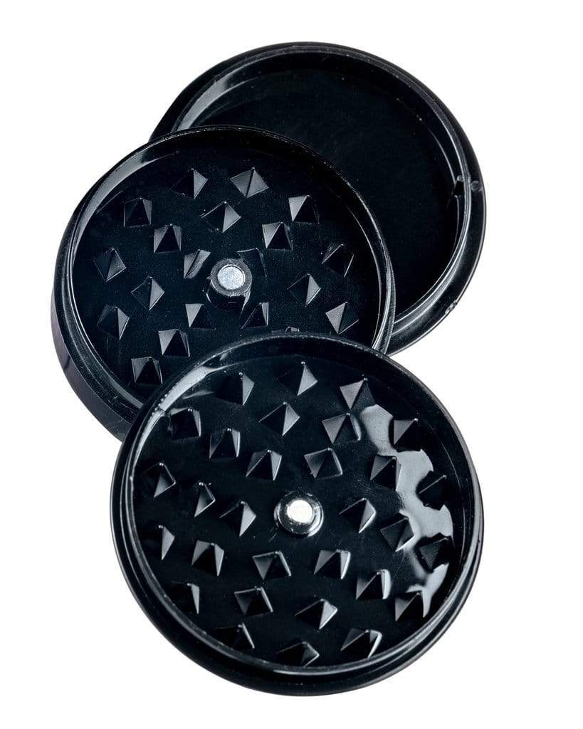 A top-down view of the Travel Herb Grinder & Stash Jar, featuring a dark, circular container with textured detailing. A top-down view of the Travel Herb Grinder & Stash Jar, featuring a dark, circular container with textured detailing.