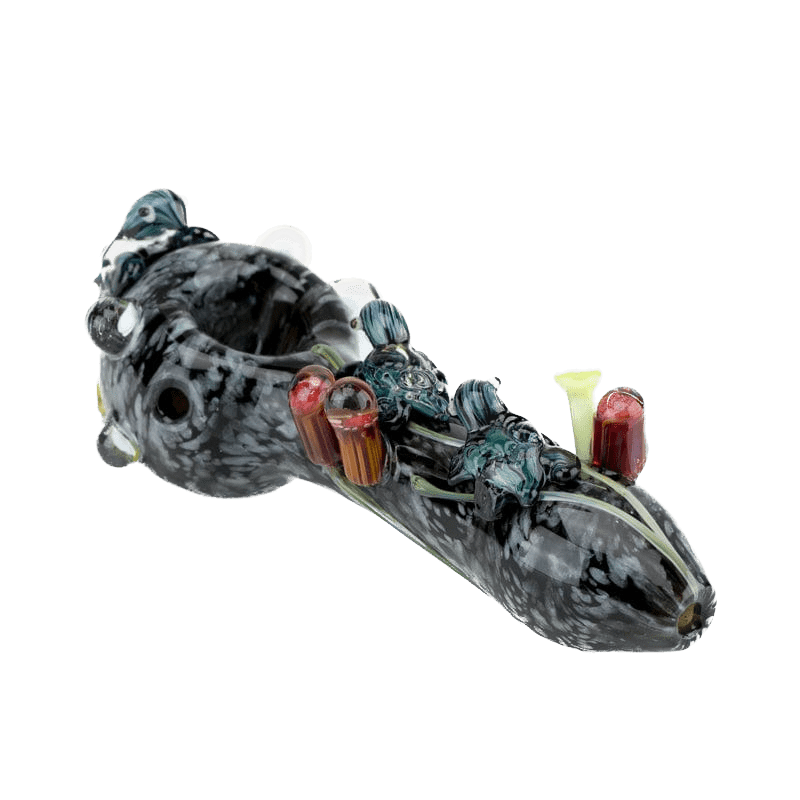 A side view of the East Australian Current Small Spoon Pipe, featuring a sculpted glass design with intricate swirls. A side view of the East Australian Current Small Spoon Pipe, featuring a sculpted glass design with intricate swirls.