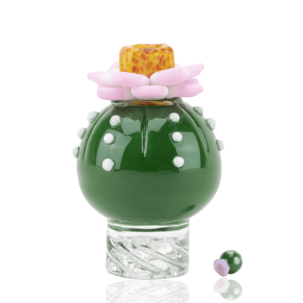 The Peyote Spinner Cap is pictured from a low angle, resting on a reflective surface with a swirling glass base. The Peyote Spinner Cap is pictured from a low angle, resting on a reflective surface with a swirling glass base.