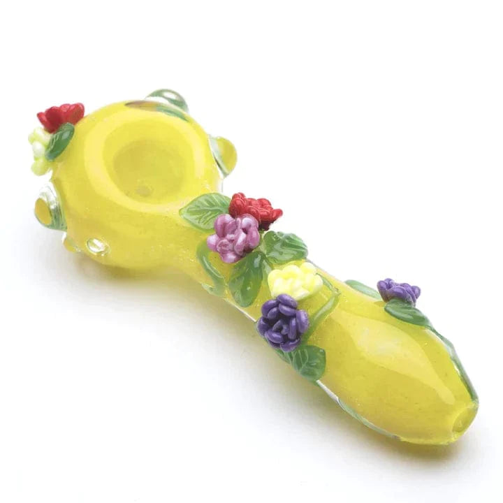A side view of the Rainbow Garden Spoon Pipe, decorated with colorful flower details against a plain white background. A side view of the Rainbow Garden Spoon Pipe, decorated with colorful flower details against a plain white background.