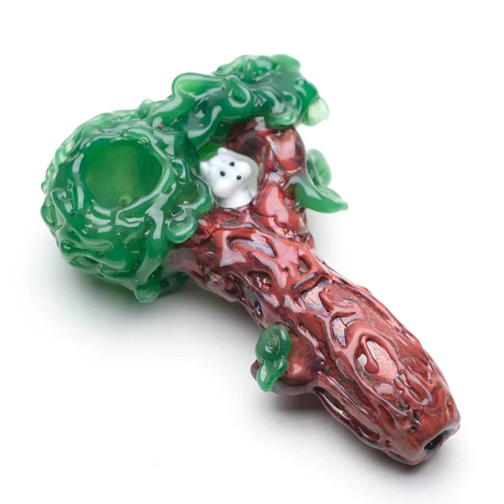 A close-up, angled view of the Squirrel's Nest Hand Pipe, featuring a textured, green-and-brown glass design resembling a cozy nest. A close-up, angled view of the Squirrel's Nest Hand Pipe, featuring a textured, green-and-brown glass design resembling a cozy nest.