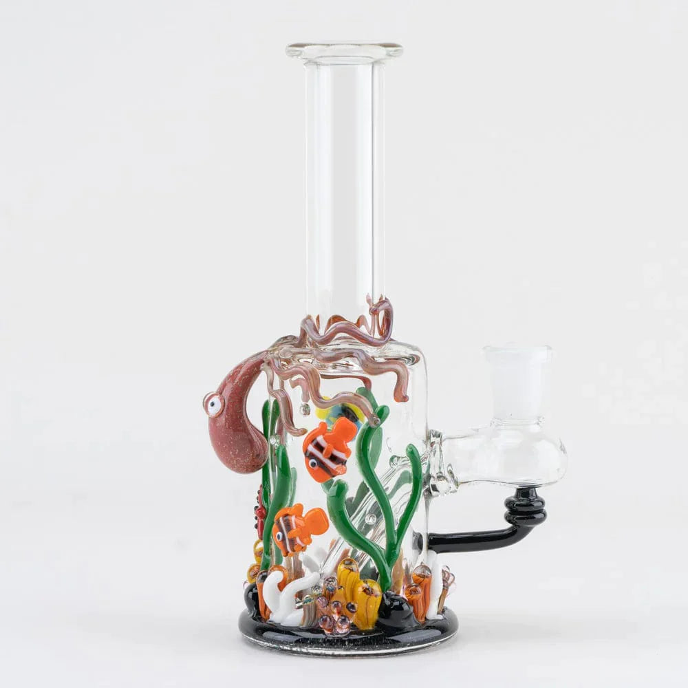 A front view of the Under the Sea Mini-Tube Rig shows colorful aquatic details within clear glass, set against a plain white background. A front view of the Under the Sea Mini-Tube Rig shows colorful aquatic details within clear glass, set against a plain white background.