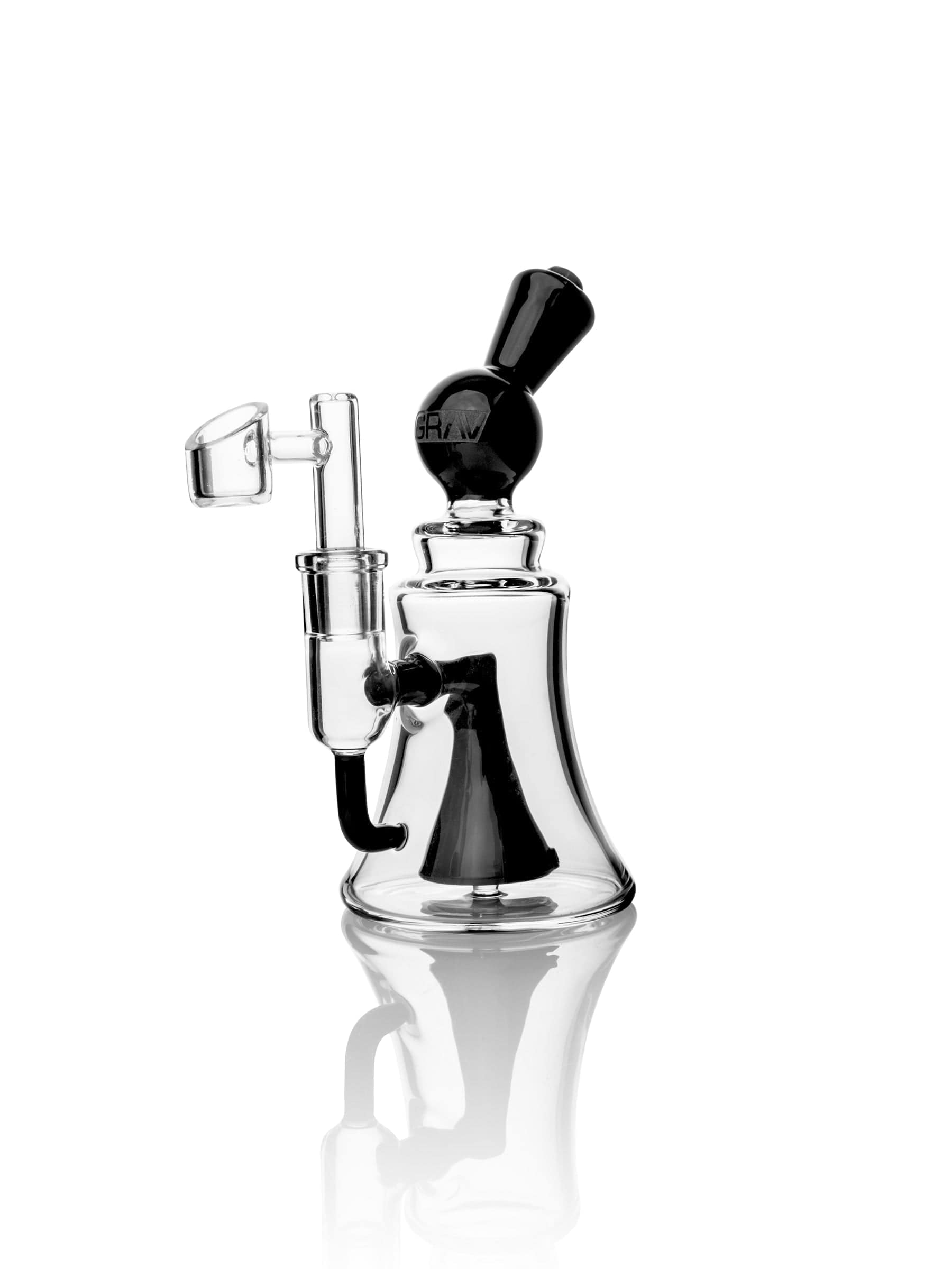 A side view of the Orbis Coppa Dab Rig with a clear glass body and distinct rounded shape, reflected on a glossy surface. A side view of the Orbis Coppa Dab Rig with a clear glass body and distinct rounded shape, reflected on a glossy surface.