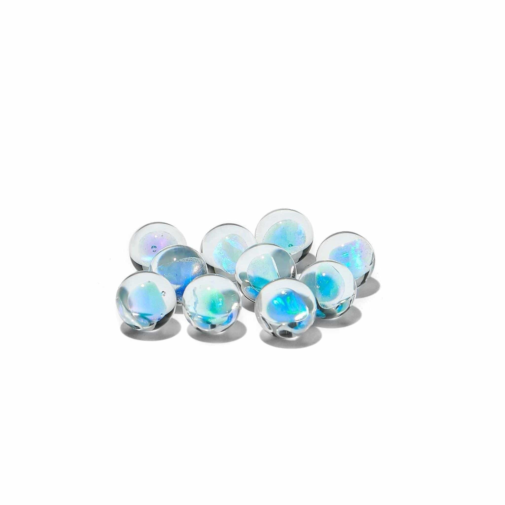 A close-up, top-down view of several Blue Opal Terp Pearls, showcasing their rounded, translucent shapes and iridescent sheen. A close-up, top-down view of several Blue Opal Terp Pearls, showcasing their rounded, translucent shapes and iridescent sheen.
