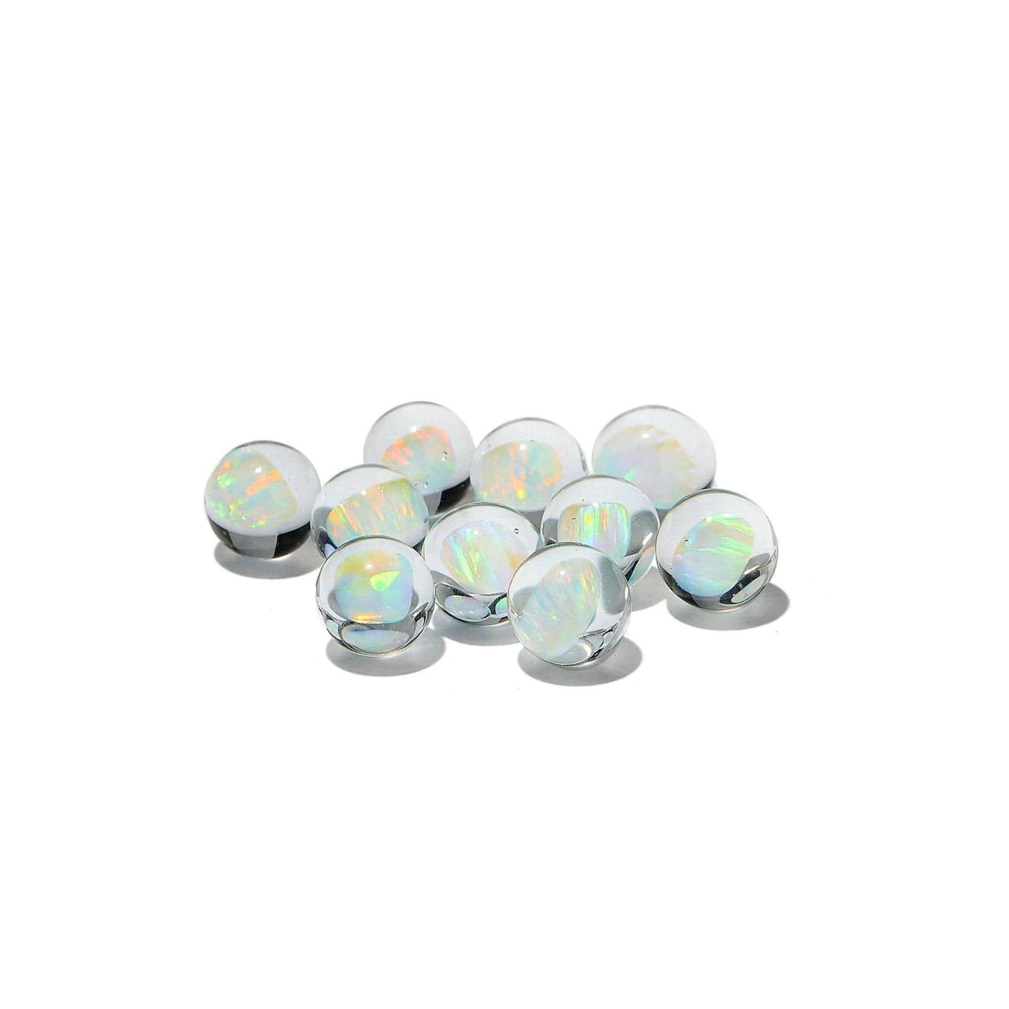 A top-down view of several White Opal Terp Pearls, displaying their iridescent sheen against a plain white background. A top-down view of several White Opal Terp Pearls, displaying their iridescent sheen against a plain white background.
