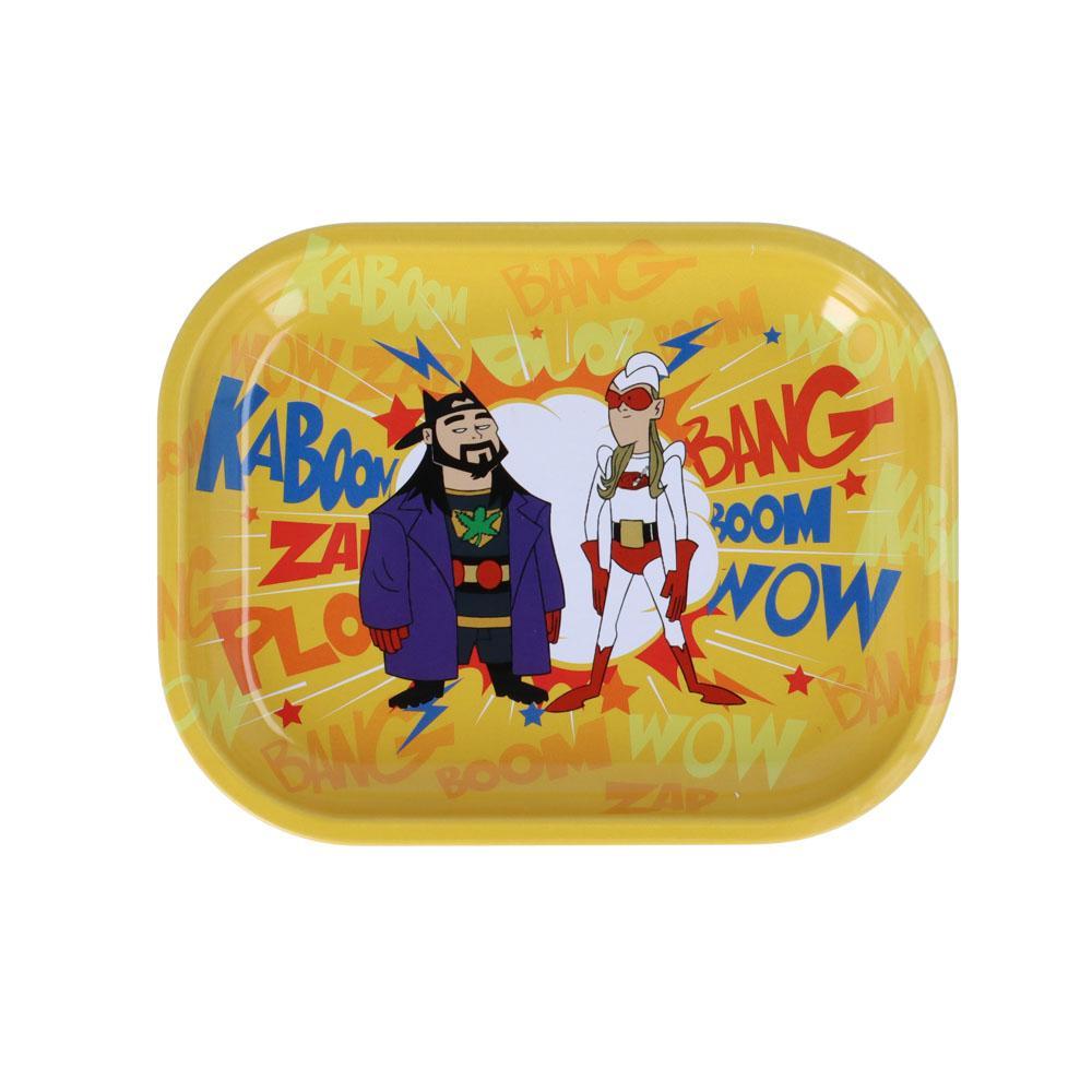 A vibrant, eye-level shot of the Bluntman & Chronic Superhero Rolling Tray featuring cartoon characters against a bright yellow background. A vibrant, eye-level shot of the Bluntman & Chronic Superhero Rolling Tray featuring cartoon characters against a bright yellow background.