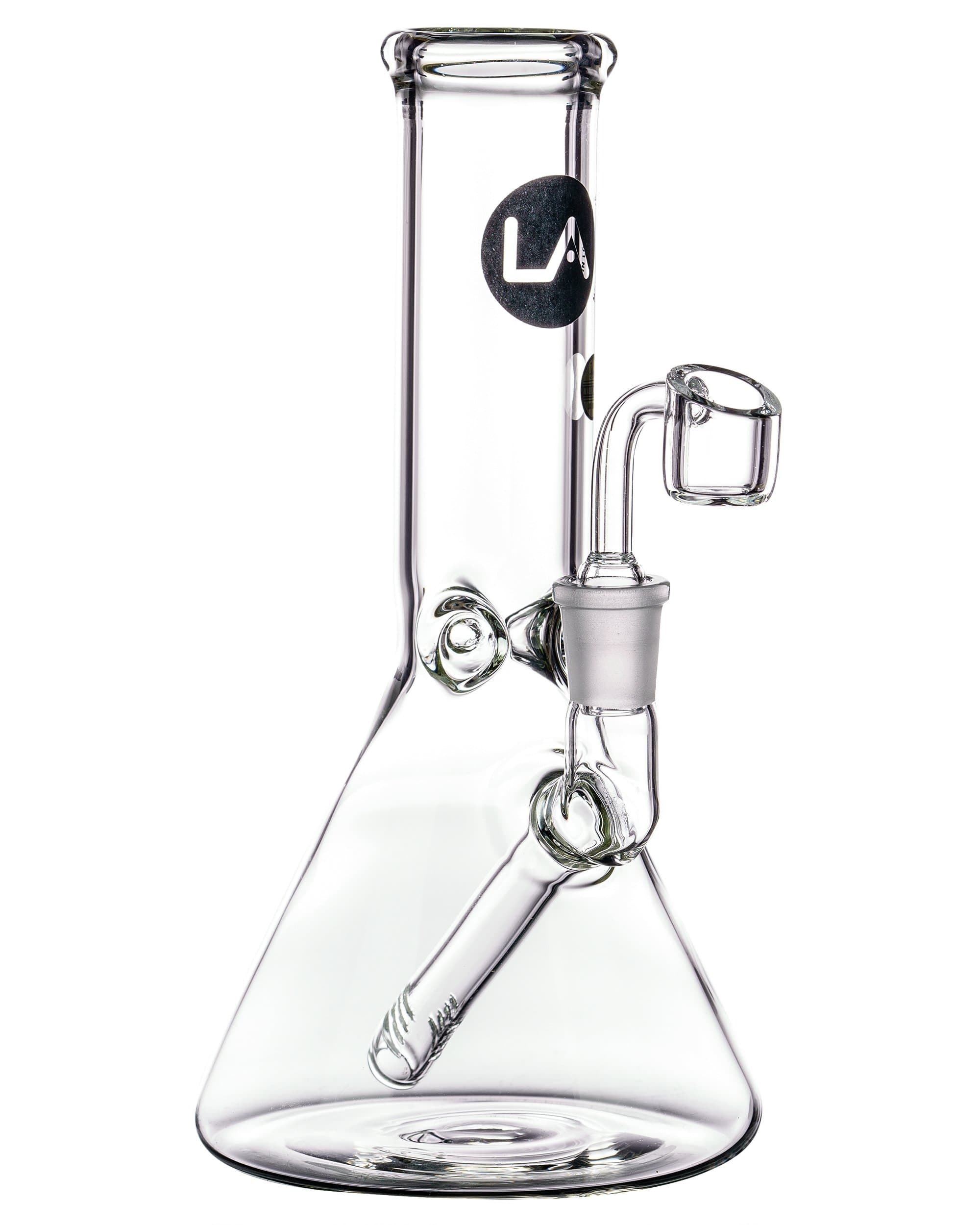 Front view of the Heavy Mini Beaker Dab Rig, a clear glass rig with a wide base and curved neck. Front view of the Heavy Mini Beaker Dab Rig, a clear glass rig with a wide base and curved neck.